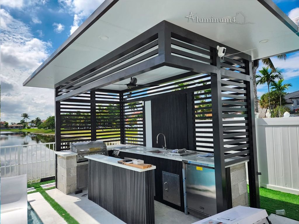 Covered outdoor kitchen with grill island by the lake
