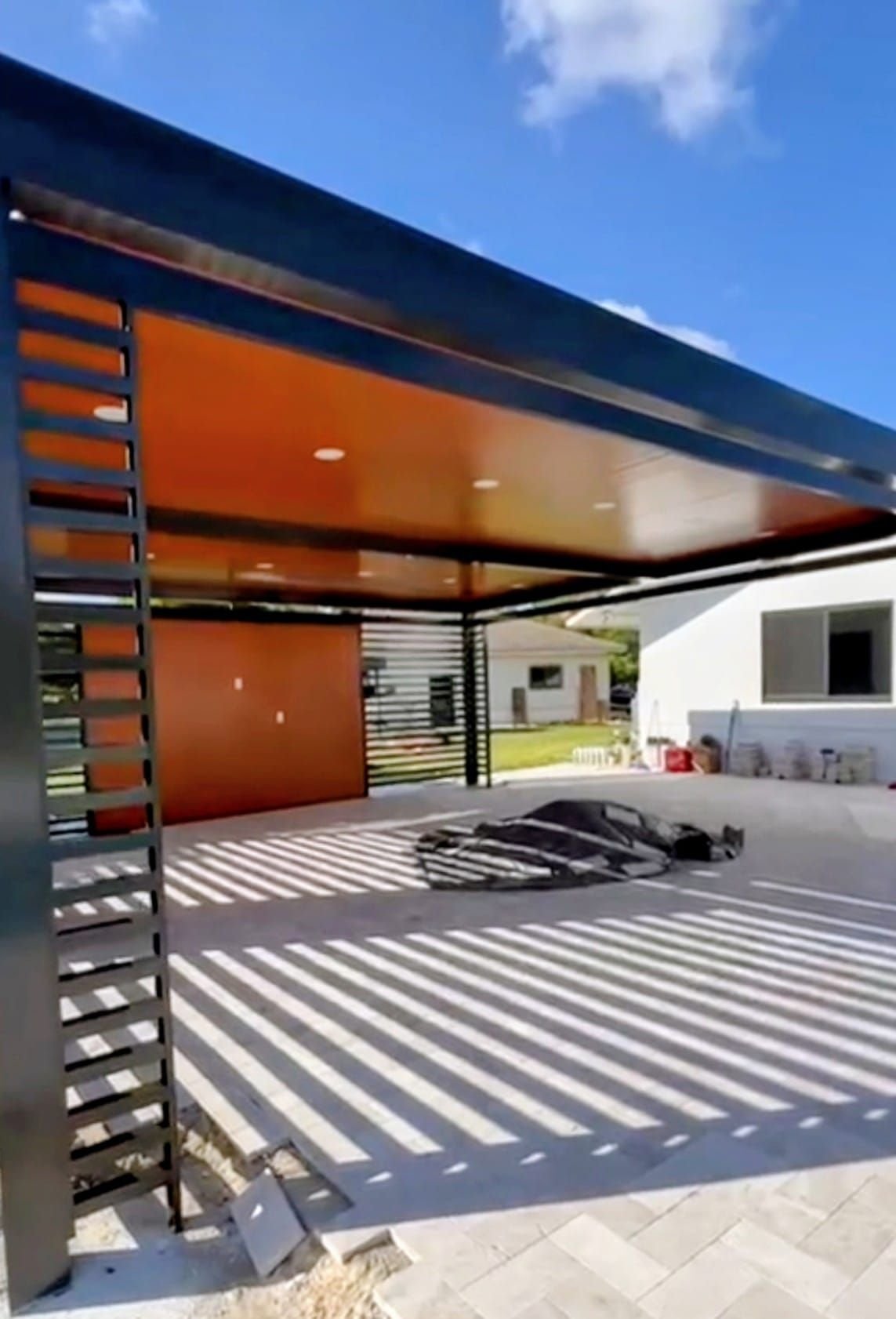 Sunlight through the louvered slats of the Enzo pergola