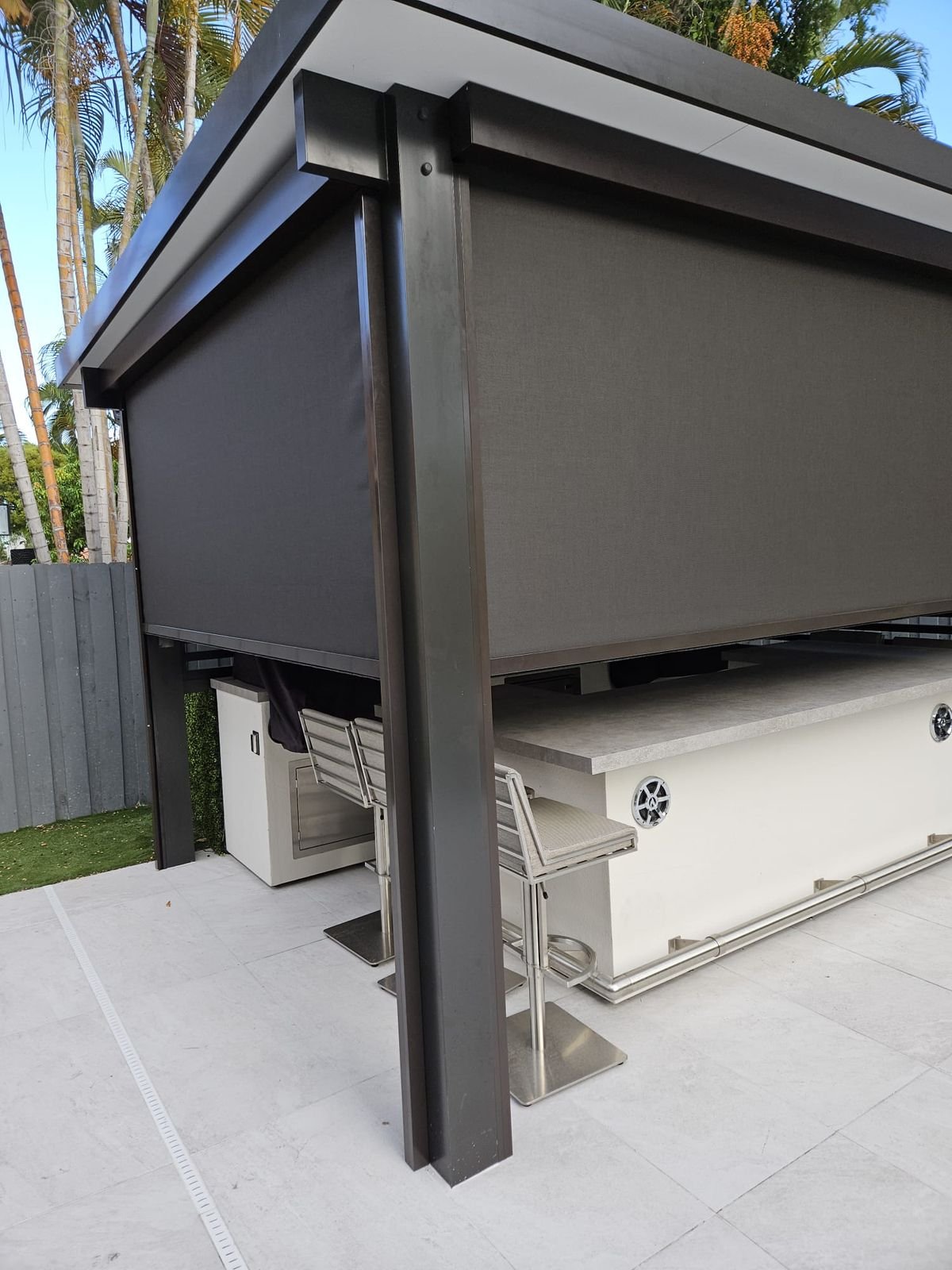 Motorized privacy screens on outdoor cabana