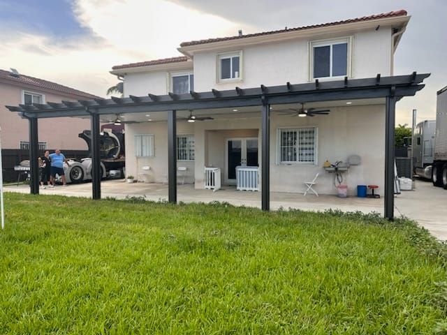 Aluminum patio cover attached to two-story home